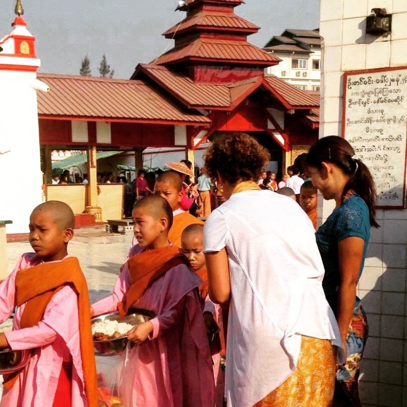 Remise d'offrandes à de jeunes filles bouddhistes lors du Nouvel An à Inle Lake au Myanmar